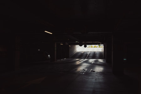 Empty underground garage. Empty parking lot with overhead dim lightの写真素材
