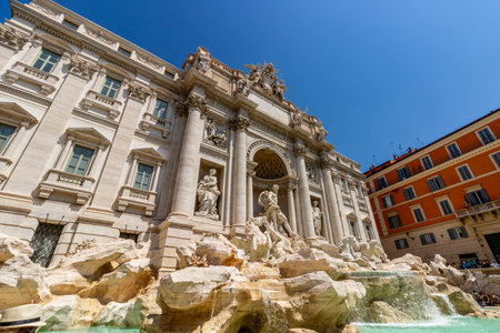 Famous landmark of Fontana di Trevi with historic statues and flowing water in Rome Italyの写真素材