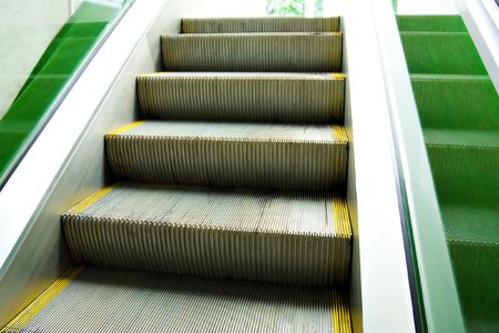 Green steps of moving escalatorの写真素材