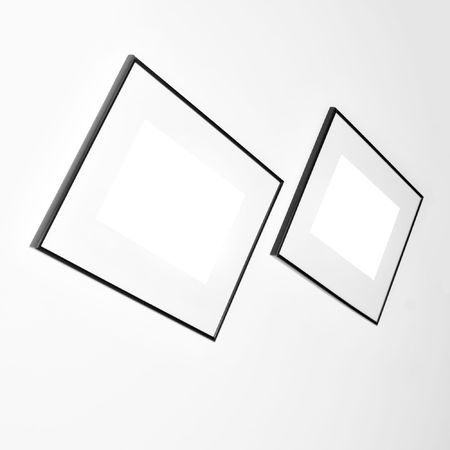 diagonal empty two frames on white wall in museumの写真素材