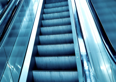 diminishing stairway of blue empty business escalatorの写真素材