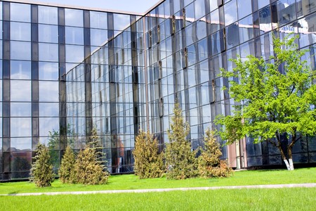 glass buildings and blooming apple trees garden in springの写真素材