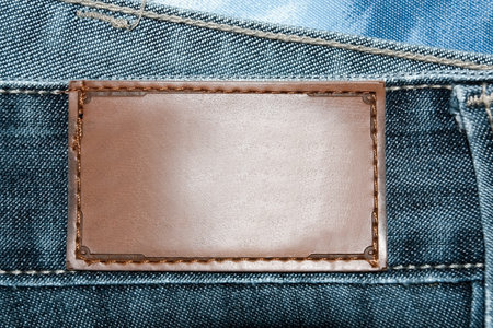 fabric of brown leather jeans label isolated