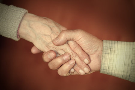 handclasp between elderly people