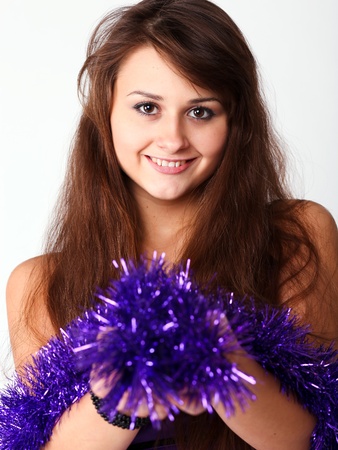 portrait of beautiful young girl with christmas garlandの写真素材