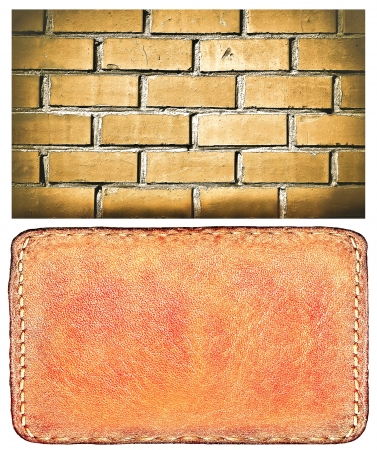 textured materials: clear surface of leather blank brown label closeup view, perspective and successful business concept of promotion products, and grungy red brick wall isolated over white backgroundの写真素材
