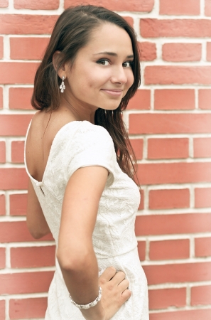 closeup portrait of pretty tender beautiful young female face with clear skin and delicate complexion in the summer evening sunshine in natureの写真素材