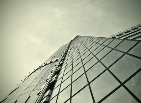 Panoramic and perspective wide angle view to steel blue background of glass high rise building skyscrapers in modern futuristic downtown at night Business concept of successful industrial architectureの写真素材