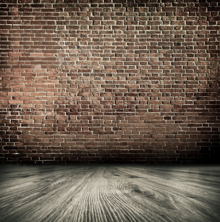 Empty black old spacious room with stone grungy wall and wooden weathered dirty floor, vintage background texture of brickwallの写真素材