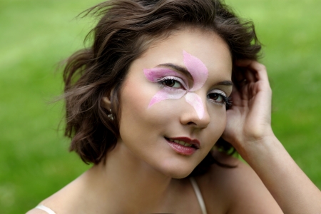 portrait of pretty beautiful young girl in the evening sunshine laying in natureの写真素材