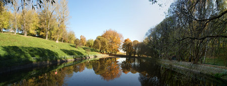 Fall in the forest. Reflection of autumn trees in the pond