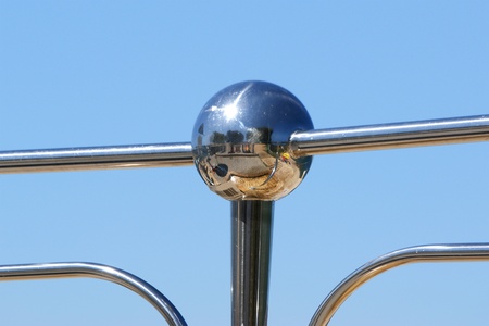 Detail of beach shower of shiny metal on the background of a clear summer skyの写真素材
