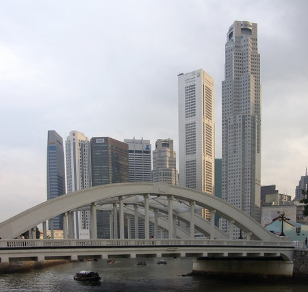 Singapore. The arch bridge through Singapore-river against high skyscrapers in business quarter of Singaporeのeditorial素材