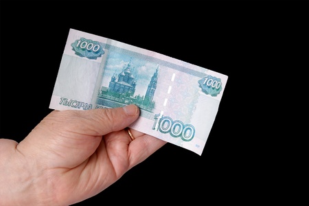 Hand older man holding banknotes, isolated on blackの写真素材