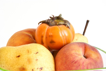 Still life, natural persimmon, pear and peach on a white backgroundの写真素材