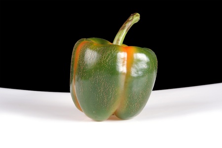 Large multi-colored pepper in a white and black backgroundの写真素材