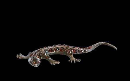 Jewelery - lizard figurine made of metal with natural grenades, isolationの写真素材