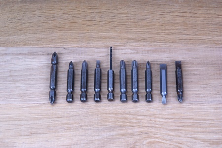 Replacement nozzles for a screwdriver against the backdrop of a tree, close-upの写真素材