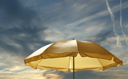 Beach umbrella (sunshade) against the clear summer sky