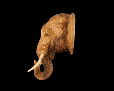 Sculpture (wood) picture elephant head. Isolated on pure blackの写真素材