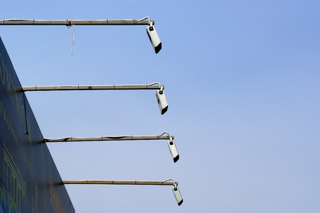 Lamps for the lighting of a billboard on a background of blue skyの写真素材