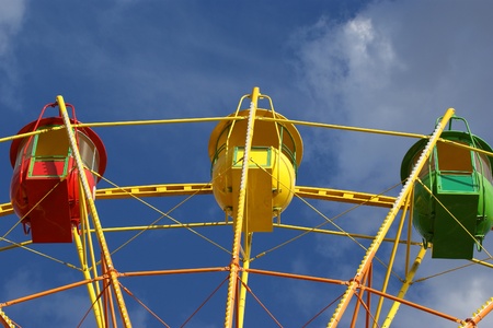 Attraction (Carousel) Ferris wheel on the background of the cloudy skyの写真素材