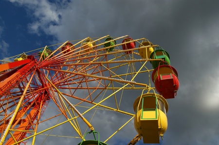 Attraction (Carousel) Ferris wheel on the background of the cloudy skyの写真素材
