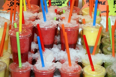 Fresh juice in plastic cups with tubes for drinkingのeditorial素材
