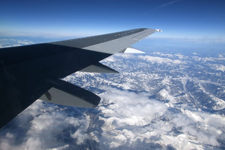 View of airplane wing, clouds and the Earth from the airplaneの写真素材