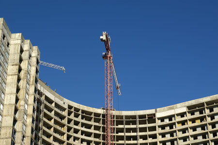 Building crane at the background of building under construction