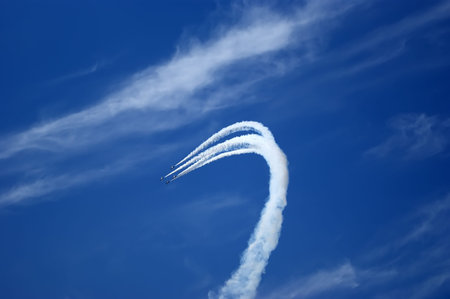 Flight of modern combat fighters on the sky background