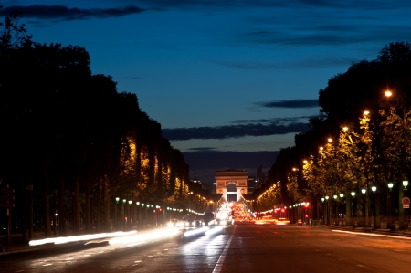Champs-Elysees avenue at night with the Triumphal Arch in the background, Paris, France の写真素材