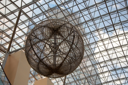 A large metal ball against the glass roofのeditorial素材