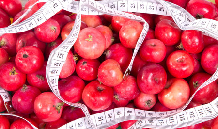 healthy food. Delicious apples with measuring tape on a white background