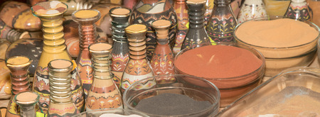 traditional local souvenirs in Jordan- bottles with sand and shapes of desert and camels の写真素材