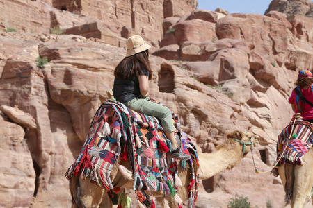 Tourists visiting the ancient ruins of Petra on camels , Jordanのeditorial素材