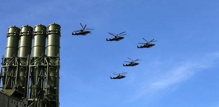 Modern Russian anti-aircraft missiles and military aircrafts fly in formation against the sky