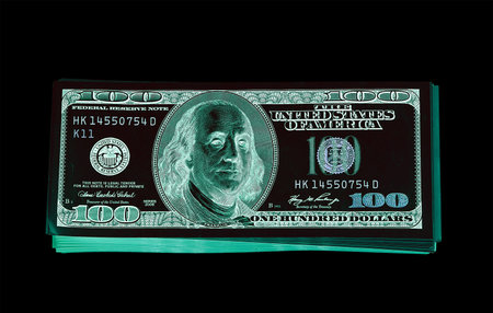 One hundred dollar bills (banknotes )  close up, U.S. currency-- in UV light protectionの写真素材