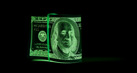 One hundred dollar bills (banknotes )  close up, U.S. currency-- in UV light protectionの写真素材