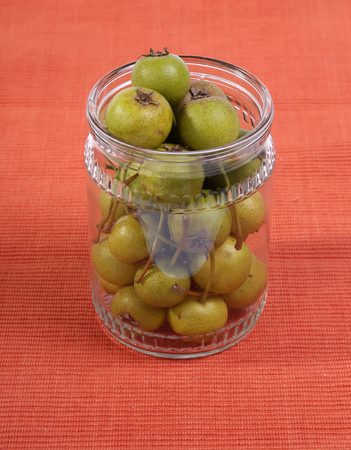 natural small green pears in a glass jarの写真素材