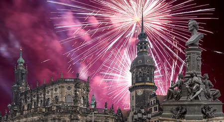 Sculpture on the Bruhl Terrace and  Hofkirche or Cathedral of Holy Trinity and holiday fireworks - baroque church in Dresden, Sachsen, Germanyの写真素材
