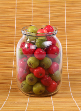 Still-life with fresh natural red rowan berries and small green pearsの写真素材