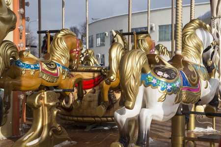 Old classic French vintage carousel horse in a holiday park (close up). Merry-go-round with horses  の写真素材