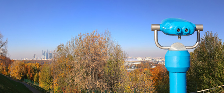 Touristic telescope viewer (binoculars) and Panoramic view of Sparrow Hills or Vorobyovy Gory observation (viewing) platform-- is on a steep bank 85 m above the Moskva river, or 200 m above sea level. Moscow, Russiaのeditorial素材