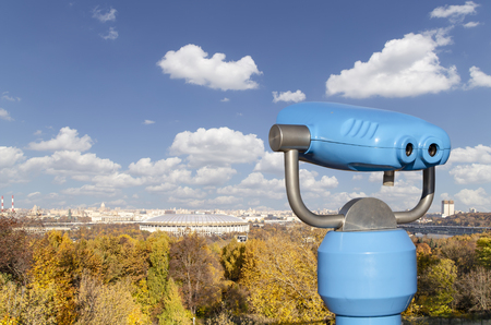 Touristic telescope viewer (binoculars) and view of central Moscow from Sparrow Hills or Vorobyovy Gory observation (viewing) platform-- is on a steep bank 85 m above the Moskva river, or 200 m above sea level. Moscow, Russiaのeditorial素材