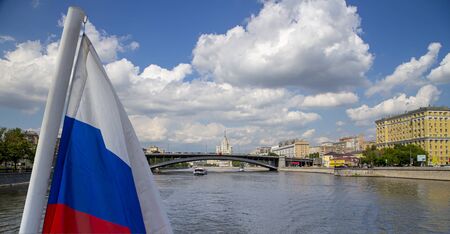 Russia flag and Moskva River and embankments (view from tourist pleasure boat). Moscow, Russiaの写真素材
