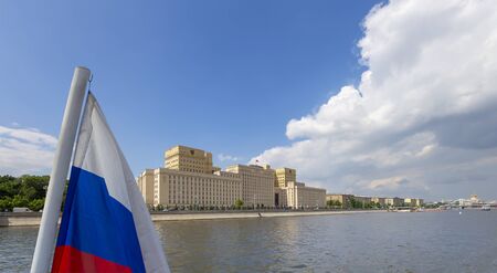 Russia flag and Main Building of the Ministry of Defence of the Russian Federation -- is the governing body of the Russian Armed Forces. Moscow, Russiaの写真素材
