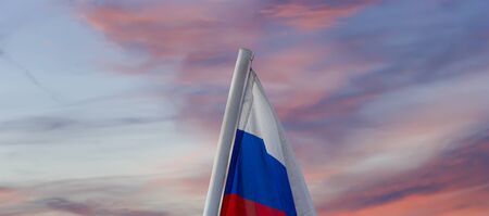 Russia flag waving in the wind against the sky. Three colors of Russian wavy flag as a patriotic symbolの写真素材