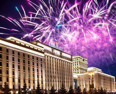 Main Building of the Ministry of Defence of the Russian Federation-- is the governing body of the Russian Armed Forces and celebratory colorful fireworks exploding in the skies. Moscow, Russiaの写真素材