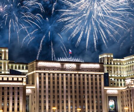 Main Building of the Ministry of Defence of the Russian Federation-- is the governing body of the Russian Armed Forces and celebratory colorful fireworks exploding in the skies. Moscow, Russiaの写真素材